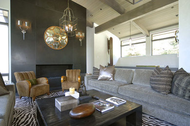 This is an example of a large contemporary open concept living room in Denver with beige walls, a standard fireplace and a concrete fireplace surround.