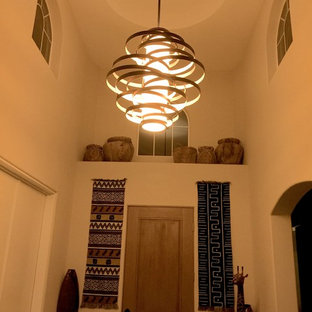 Inspiration for a mid-sized eclectic foyer in Other with porcelain floors, a single front door, a medium wood front door, grey floor and white walls.