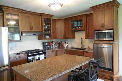 Mid-sized cottage l-shaped medium tone wood floor eat-in kitchen photo in Cedar Rapids with an undermount sink, shaker cabinets, brown cabinets, stainless steel appliances and an island