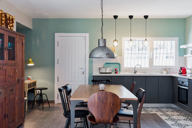 Example of a mid-sized danish laminate floor and gray floor great room design in Alicante-Costa Blanca with green walls