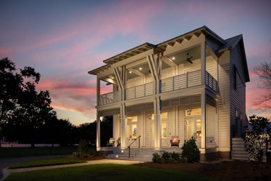 Inspiration for a large coastal white two-story wood house exterior remodel in Birmingham