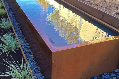 Design ideas for a modern courtyard water fountain landscape in Seattle.