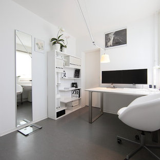 Small modern study in Berlin with white walls, a freestanding desk, no fireplace and lino flooring.