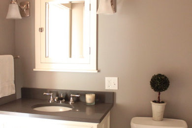 Inspiration for a craftsman master white tile and porcelain tile porcelain tile alcove bathtub remodel in Seattle with an undermount sink, shaker cabinets, white cabinets, solid surface countertops, a two-piece toilet and gray walls