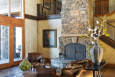 Inspiration for a large timeless formal and open concept dark wood floor and brown floor living room remodel in Other with brown walls, a standard fireplace, a stone fireplace and no tv
