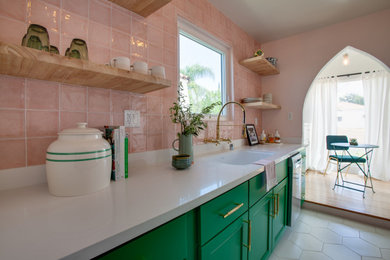 Inspiration for a small eclectic galley ceramic tile and white floor eat-in kitchen remodel in Los Angeles with a drop-in sink, flat-panel cabinets, green cabinets, quartzite countertops, pink backsplash, ceramic backsplash, stainless steel appliances and white countertops