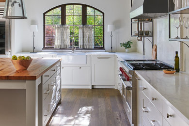 Inspiration for a large farmhouse u-shaped dark wood floor enclosed kitchen remodel in DC Metro with a farmhouse sink, recessed-panel cabinets, gray cabinets, wood countertops, white backsplash, marble backsplash, stainless steel appliances, an island and white countertops