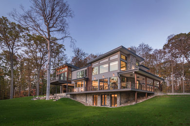 Inspiration for a large contemporary beige two-story wood exterior home remodel in Cleveland