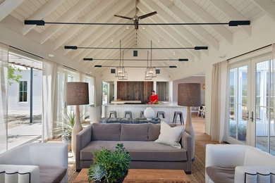 Country open concept medium tone wood floor living room photo in San Francisco with white walls