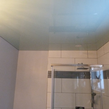 Mint green high gloss Phoenix Stretch Ceiling in a bathroom above the shower