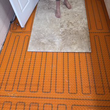 Curd-less walk-in shower; heated floors in bathroom + shower+bench LED