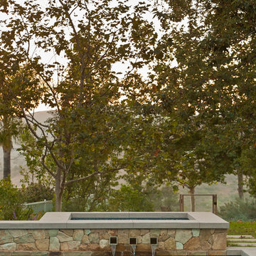 Stone spa with glass tile waterline