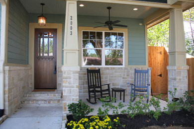 This is an example of a mid-sized arts and crafts front yard verandah in Houston with a roof extension.