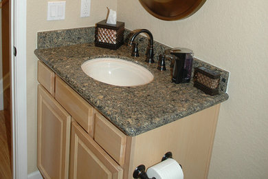 Inspiration for a large master beige tile and ceramic tile ceramic tile bathroom remodel in Denver with a drop-in sink, raised-panel cabinets, light wood cabinets, granite countertops, a one-piece toilet and beige walls