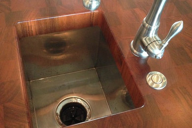 Trendy kitchen photo in Austin with a drop-in sink and wood countertops