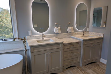 Inspiration for a mid-sized transitional master white tile and porcelain tile porcelain tile, multicolored floor and double-sink bathroom remodel in Other with shaker cabinets, beige cabinets, a two-piece toilet, blue walls, an undermount sink, quartz countertops, white countertops, a niche and a built-in vanity