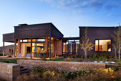 This is an example of a large contemporary one-storey exterior in Denver with wood siding.