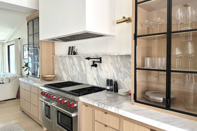 Inspiration for a mid-sized modern single-wall light wood floor, brown floor and wood ceiling kitchen pantry remodel in Orange County with a farmhouse sink, shaker cabinets, light wood cabinets, granite countertops, white backsplash, granite backsplash, stainless steel appliances, an island and white countertops