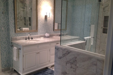 Large transitional master bathroom in Other with raised-panel cabinets, white cabinets, an alcove shower, white tile, marble, blue walls, marble floors, white floor, a hinged shower door and an undermount sink.