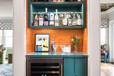 Home bar - contemporary medium tone wood floor and brown floor home bar idea in New York with wood countertops, orange backsplash and turquoise countertops