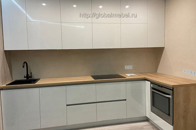 Design ideas for a small scandinavian l-shaped separate kitchen in Moscow with flat-panel cabinets, white cabinets and stainless steel appliances.