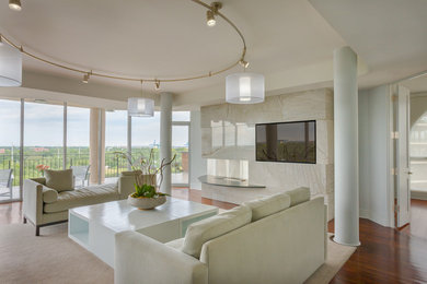 Inspiration for a mid-sized contemporary open concept medium tone wood floor living room remodel in New Orleans with white walls, a ribbon fireplace, a stone fireplace and a media wall