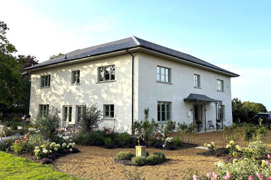 Medium sized and white classic side detached house in Other.