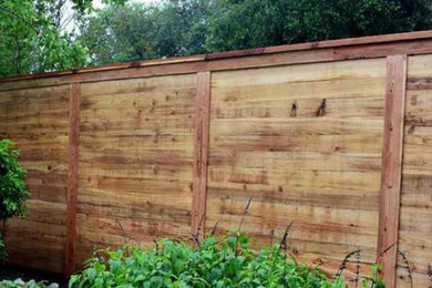 Inspiration for a farmhouse privacy backyard wood fence landscaping in Other.