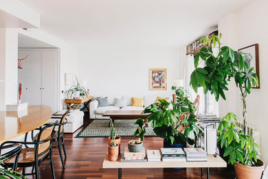 Family room - mid-sized tropical open concept dark wood floor and brown floor family room idea in Barcelona with white walls and no fireplace