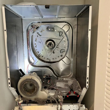 Dryer repair in Miami — drum removed, blower housing and heating element exposed