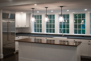 Design ideas for a large transitional u-shaped separate kitchen in Boston with white cabinets, granite benchtops, with island and black benchtop.
