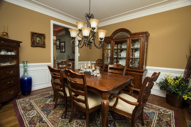 Inspiration for a mid-sized contemporary medium tone wood floor enclosed dining room remodel in DC Metro with beige walls