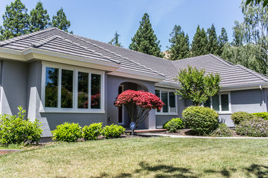 Large craftsman brown two-story stucco exterior home idea in San Francisco with a shingle roof