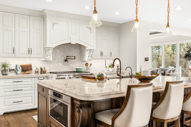 Example of a large transitional l-shaped open concept kitchen design in Detroit with flat-panel cabinets, white cabinets and an island