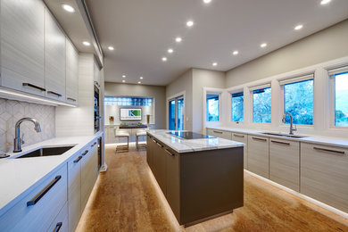 Eat-in kitchen - mid-sized contemporary galley cork floor and brown floor eat-in kitchen idea in Denver with an undermount sink, gray cabinets, white backsplash, ceramic backsplash, an island and white countertops
