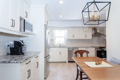 Eat-in kitchen - mid-sized transitional l-shaped porcelain tile and gray floor eat-in kitchen idea in Other with an undermount sink, recessed-panel cabinets, white cabinets, granite countertops, white backsplash, porcelain backsplash and stainless steel appliances