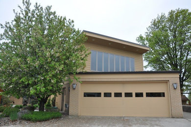 Mid-sized transitional beige two-story mixed siding exterior home photo in Cincinnati with a clipped gable roof