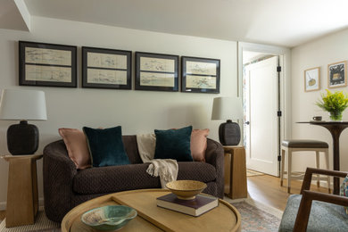 Inspiration for a small transitional medium tone wood floor and brown floor living room remodel in Seattle with white walls