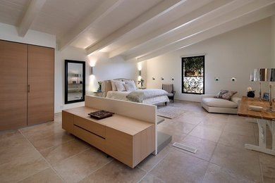 Inspiration for a large contemporary master bedroom in San Luis Obispo with white walls, limestone floors and beige floor.