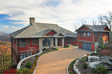 Huge arts and crafts red three-story wood house exterior photo in Charlotte with a hip roof and a shingle roof