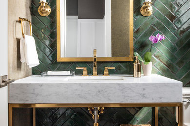 Design ideas for a small contemporary powder room in Los Angeles with dark hardwood floors, an undermount sink, brown floor, white benchtops, green tile, ceramic tile, marble benchtops, furniture-like cabinets, a one-piece toilet and green walls.