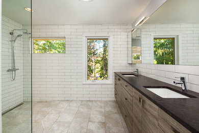 Doorless shower - large modern master white tile and porcelain tile porcelain tile doorless shower idea in Atlanta with flat-panel cabinets, dark wood cabinets, a one-piece toilet, gray walls, an undermount sink and soapstone countertops