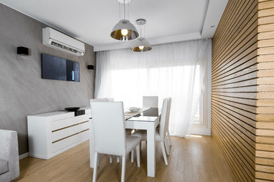 Dining room - mid-sized scandinavian light wood floor and beige floor dining room idea in Other with gray walls