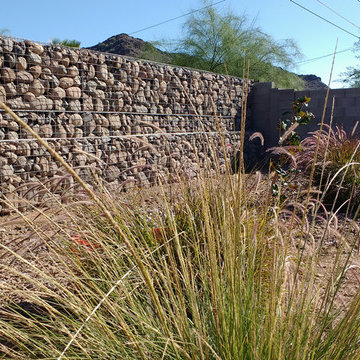 Backyard wall/fence and retaining wall in front supporting hillside construction
