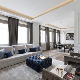 This is an example of a medium sized traditional formal open plan living room in London with white walls and medium hardwood flooring.