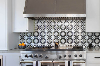 Large transitional l-shaped light wood floor and beige floor eat-in kitchen photo in Austin with an undermount sink, flat-panel cabinets, white cabinets, quartzite countertops, multicolored backsplash, ceramic backsplash, stainless steel appliances, an island and gray countertops
