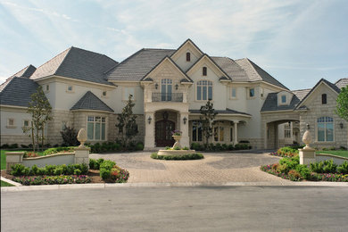 Huge elegant white two-story mixed siding house exterior photo in Orlando with a hip roof and a shingle roof