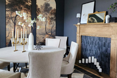Mid-sized elegant ceramic tile, black floor and wallpaper enclosed dining room photo in Austin with gray walls