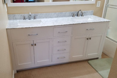 Example of a large minimalist master bathroom design in San Francisco with shaker cabinets, white cabinets, an undermount sink and marble countertops