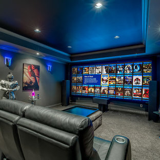 Large contemporary enclosed home cinema in Calgary with grey walls, carpet, a projector screen and grey floors.